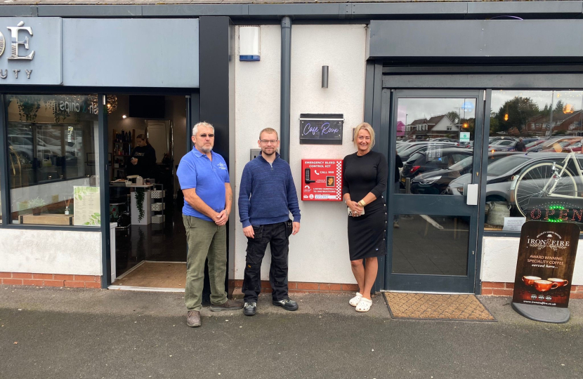 Councillor Adam Hicken, local resident Anthony Barrett and Cafe Roux owner Deb Roberts with the new bleed kit