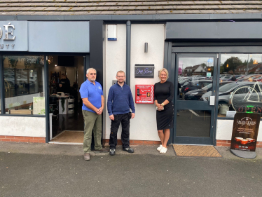 Councillor Adam Hicken, local resident Anthony Barrett and Cafe Roux owner Deb Roberts with the new bleed kit